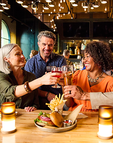 group enjoying drinks and food at 90NINETY