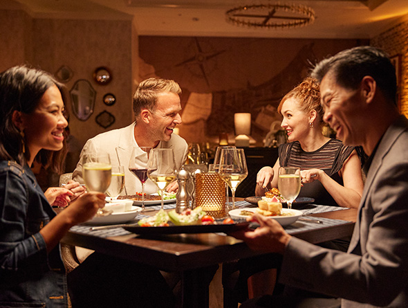 couples eating and drinking at a restaurant